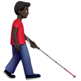 mężczyzna z białą laską: karnacja ciemna i zwrócony w prawo